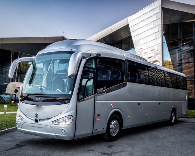 A 50-seater coach parked at a scenic location